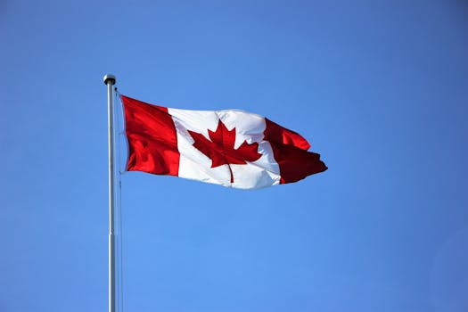 pexels-photo-2448946-2448946 Canadian flag waving proudly against a clear blue sky in Victoria, BC.
